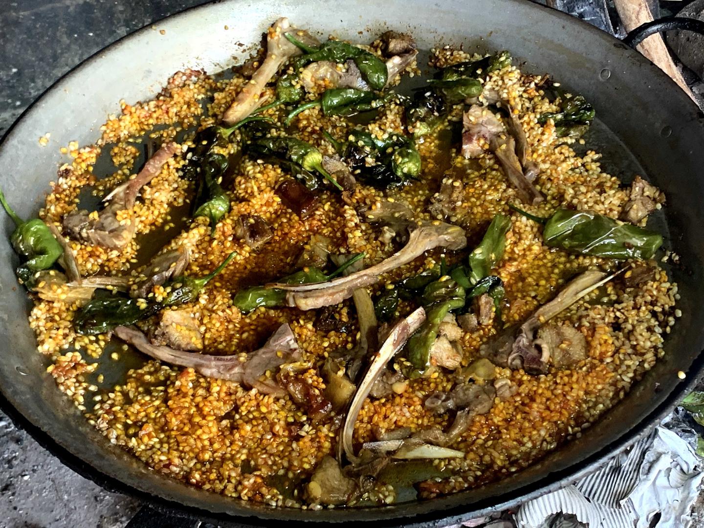 Añadir chuletas y pimientos a la paella